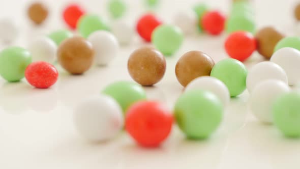 Colorful round candies on white reflective surface 4K 2160p UltraHD footage - Colorful round bonbons