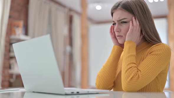 Tired Young Woman Having Headache in Office