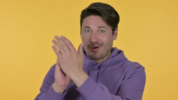 Positive Man Clapping, Yellow Background 