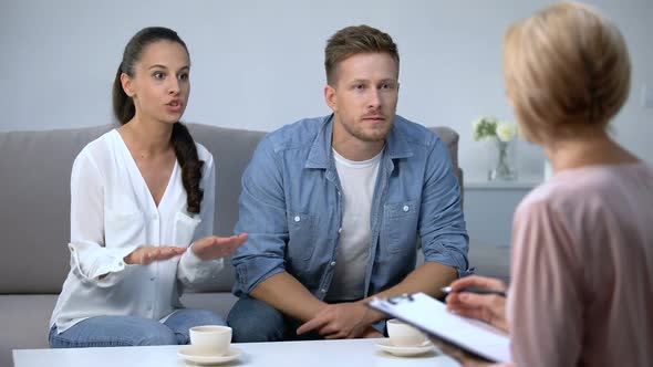 Couple Arguing at Therapy Session With Psychologist Family Misunderstanding