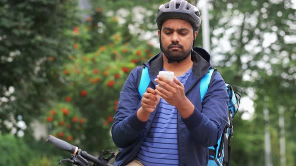 Delivery Man with Bag and Bicycle Calling on Phone