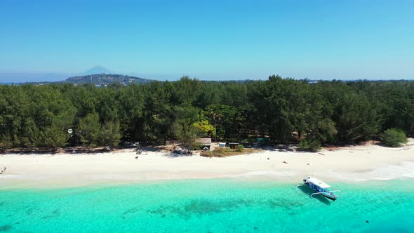 Wide above abstract shot of a sandy white paradise beach and blue water background in colorful 4K