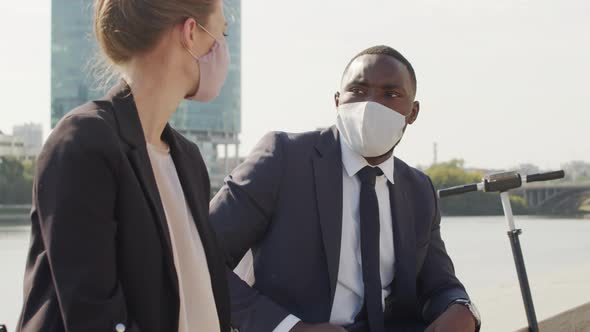 Multi-Ethnic Business Couple Chatting Outside