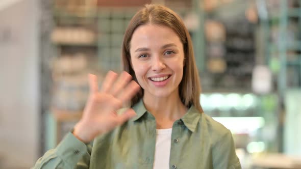 Portrait of Cheerful Woman Waving at the Camera