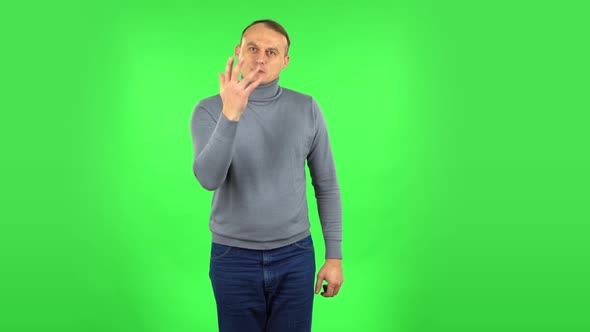 Male Is Scolding, Shaking His Index Finger and Threatening with a Fist. Green Screen