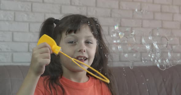 Child Blowing Soap Bubbles Indoor