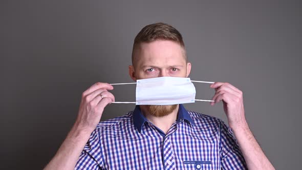 Caucasian man wearing a medical mask to protect himself from virus covid-19