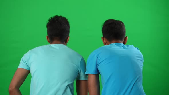 Back View Two Inspired Middle Eastern Young Men Talking Gesturing Watching Football Match on Green