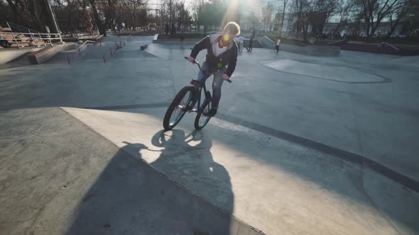 MTB Bicycle Rider Does Various Tricks While Riding in Skatepark 