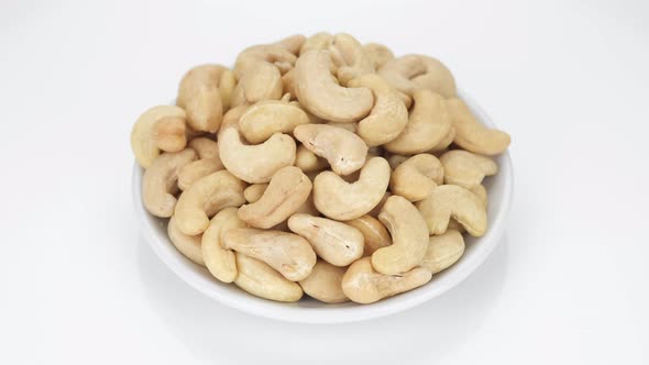 cashew nuts isolated on white background, rotation. Healthy Food. 4K UHD video