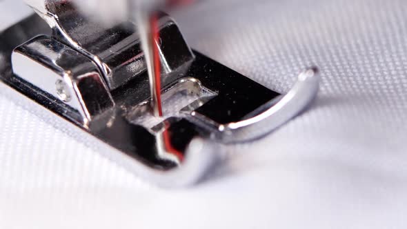 Electric Sewing Machine Makes a Red Thread Stitch. Close Up