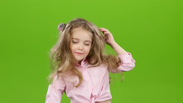 Kid with Curlers on His Head, Removes Curlers. Green Screen