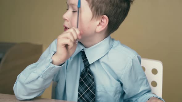 CU Tracking Schoolboy Does Homework Writes a Pen in a Notebook Uses a Triangular Ruler 2