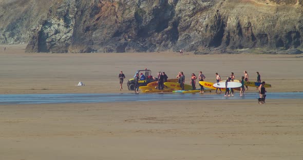 Group Of Rescue Surfers With Surfboard And Quad Bike Gather At The Perranporth Beach. - wide