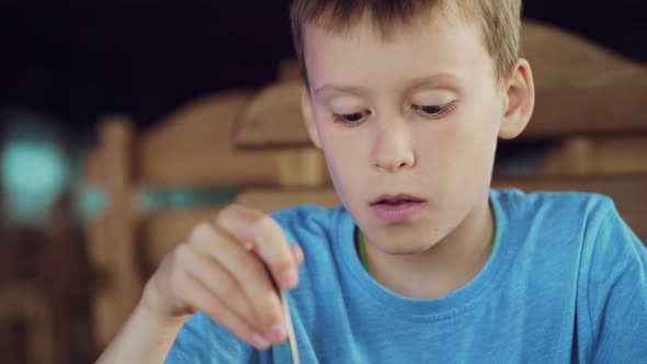 Young Boy Eating Ice Cream with Spoon