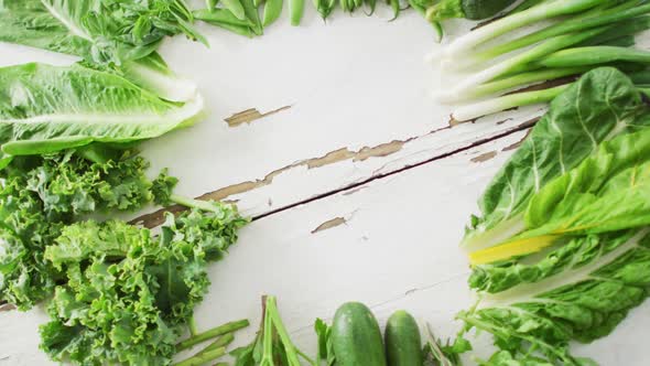 Video of fresh salad leaves with copy space on white rustic background