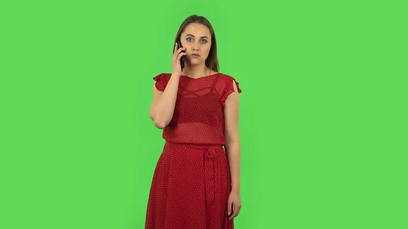 Tender Girl in Red Dress Is Talking for Mobile. Green Screen