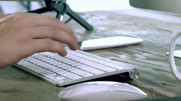 A Caucasian Male Typing on a Wireless Keyboard 04