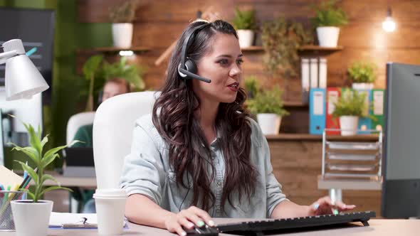 Woman Customer Support Representative Talks Using the Headset