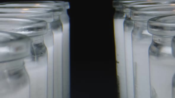 Macro Shot Moving Through Row of White Candles