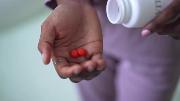 Closeup Female African American Palm with Orange Vitamin Pills