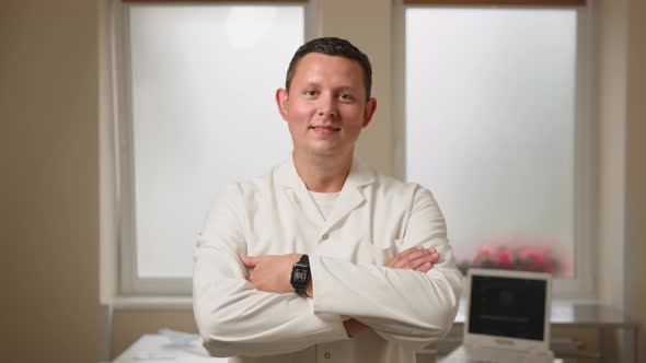 Portrait of Gynecologist in White Lab Coat Posing at Clinic