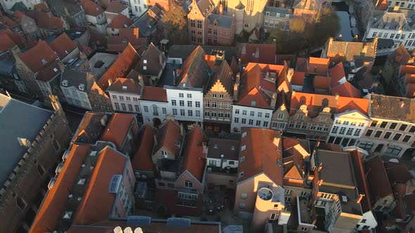 Flying over rooftops of homes near Belfry of Bruges