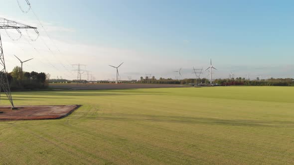 Revealed An Offshore Wind Farm With Greenery Fields In Flevoland, Netherlands. Aerial Tilt-up