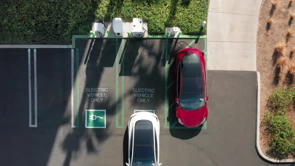  Aerial Top Down View on Electric Car Parking at the Charging Station, USA