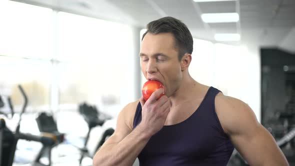 Athlete Man Eating Fresh Apple After Gym Training, Healthy Nutrition, Vitamins