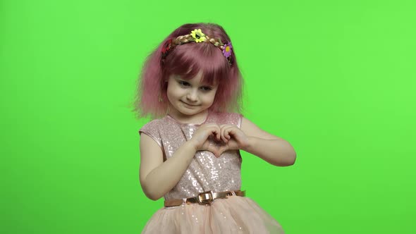 Child Girl Princess Showing Love Heart Sign with Her Hands. Mother's Day Concept