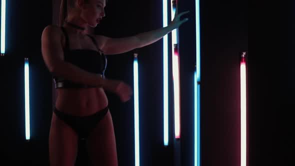 Female Stripper Dancing in Neon Lights