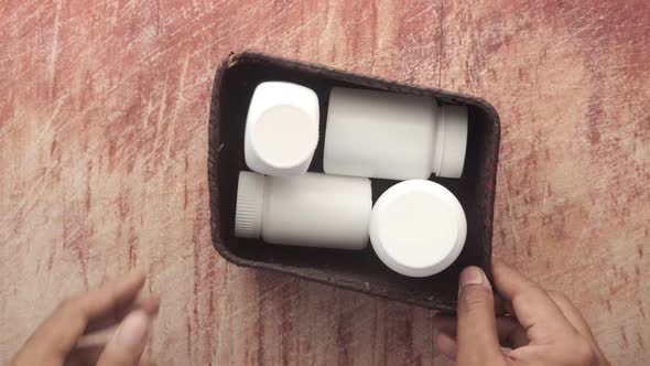 Young Man Hand Holding Medicine Pill Container