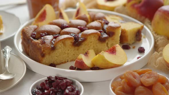 Delicious Homemade Peach or Nectarine Cake, Fresh Fruits, Marmalade, Cranberry on Stone Background