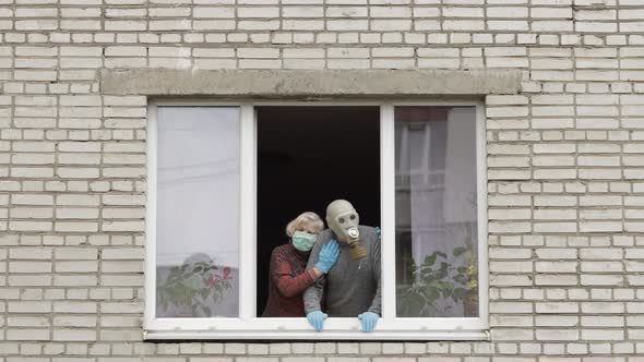 Old Grandparents Stay at Window Isolated at Home on Quarantine. Coronavirus alt