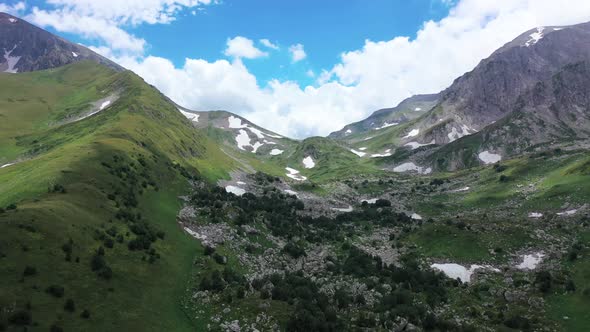 Aerial View of Mountain Pass in Adygea, Valley and Mountain Ridge. Green Trees and Bushes Among