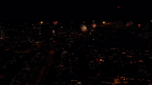 Welcoming New Year With Exploding Fireworks On Cityscape Of Iceland. Aerial Wide