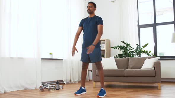 Indian Man Exercising and Doing Squats at Home