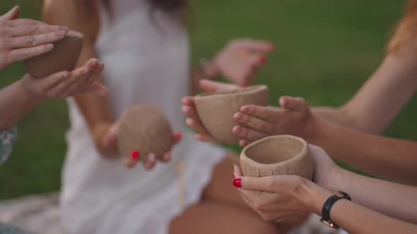 A Group of Young Attractive Women in Nature in an Open Area Sculpt From Clay Discuss the Results of