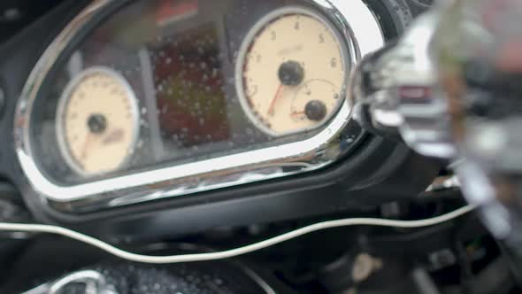 Motorcycle Speedometer and Control Panel with Raindrops, Trade Show Closeup