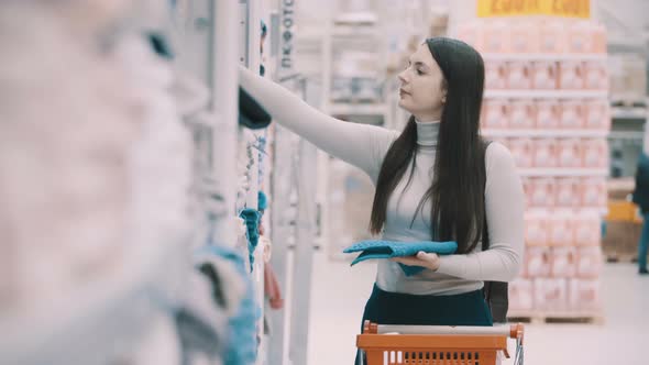  Woman Chooses Towels In Supermarket