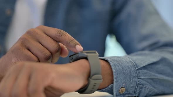 Hands of African Man Using Smartwatch Close Up