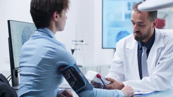 Caucasian Physician Measuring Blood Presure with a Digital Sphygmomanometer