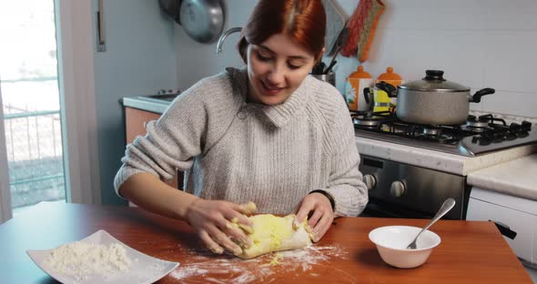 Young Girl is Making Homemade Potato Gnocchi on the Table of the Kitchen