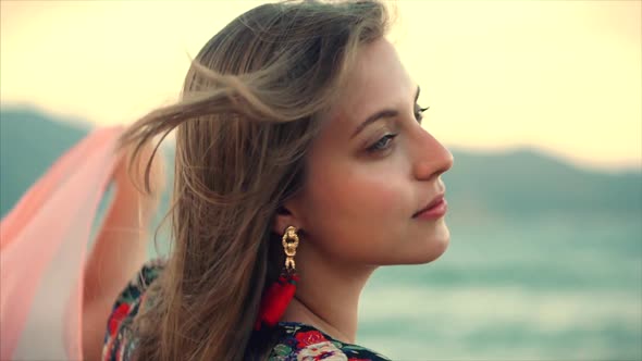 Close Up Portrait a Wonderful Brown-Haired Woman With Green Eyes with Flowing Hair in a Summer Dress