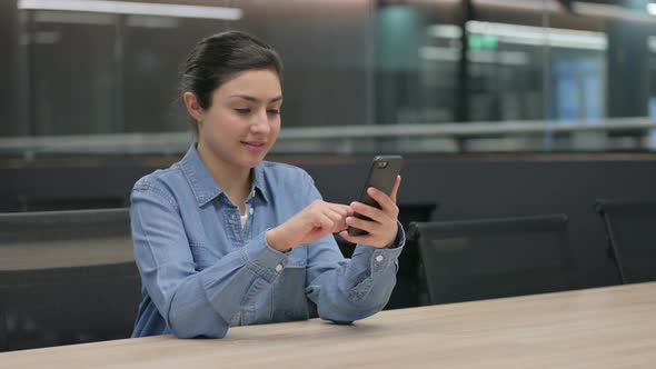 Indian Woman Using Smartphone at Work