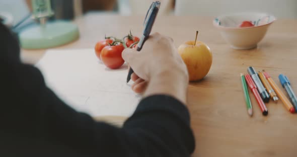 Male hands making notes in a notebook close up