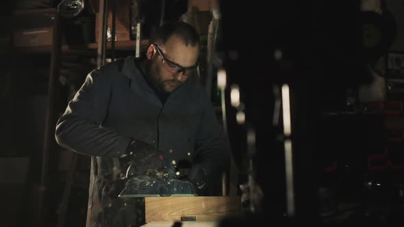 Man Works With Electric Tool. Sanding Wood.