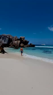 Anse Source d'Argent La Digue Seychelles Young Men on a Tropical Beach During a Luxury Vacation in