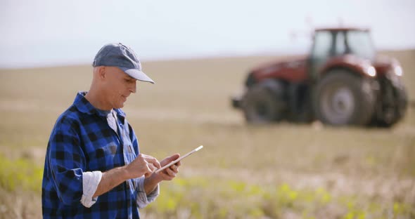 Modern Farmer Using Digital Tablet